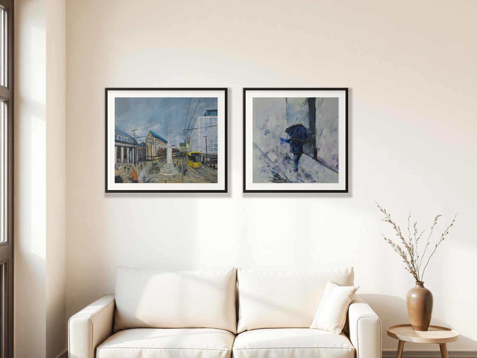 Two framed prints by Trevor Chatfield hanging above a sofa in a sunlit living room